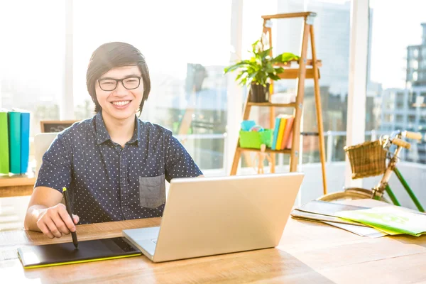 Businessman using laptop and graphic tablet — Stock Photo, Image