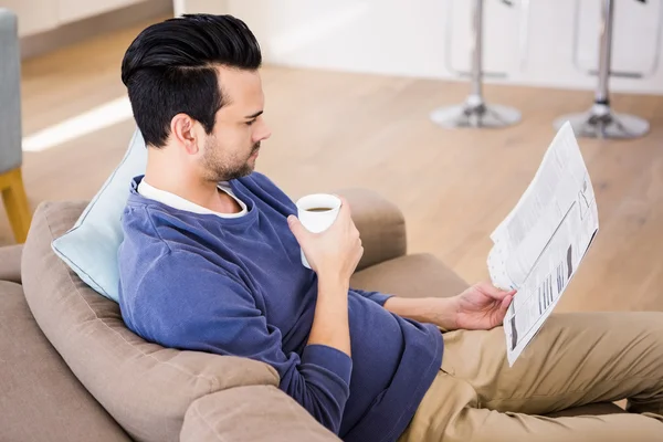 Serious man reading the news — Stock Photo, Image