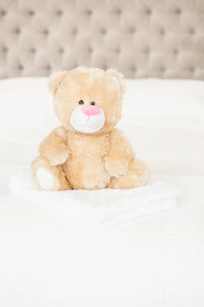 Soft teddy bear on bed — Stock Photo, Image