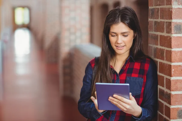 Smiling student using tablet in the hallway — Stock Photo, Image