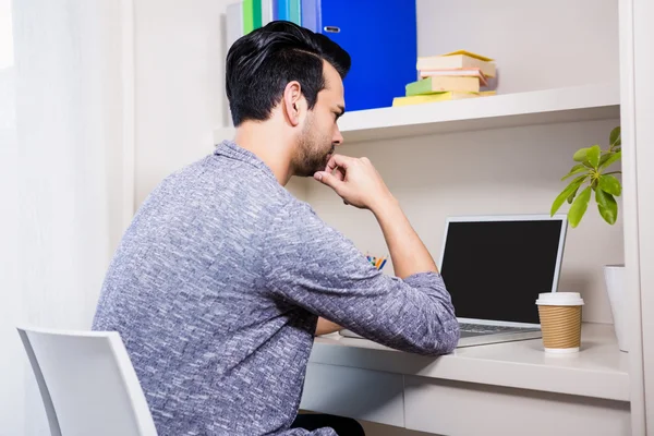 Hombre enfocado usando el ordenador portátil — Foto de Stock