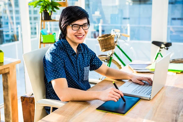 Businessman using laptop and graphic tablet — Stock Photo, Image