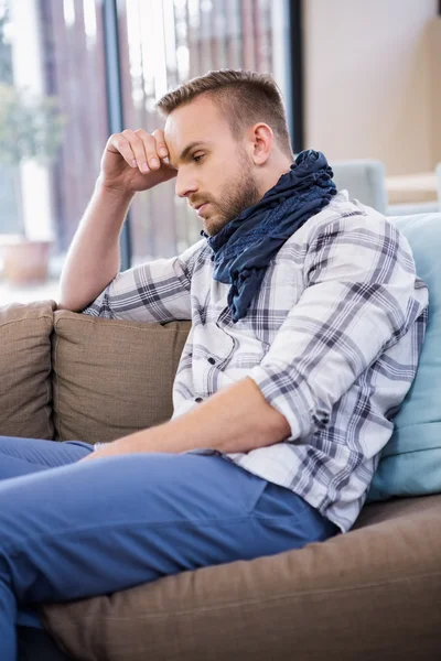 Worried man thinking on couch — Stock Photo, Image