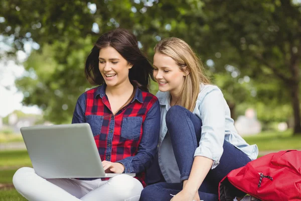 Uśmiechnięci studenci korzystający z laptopa — Zdjęcie stockowe