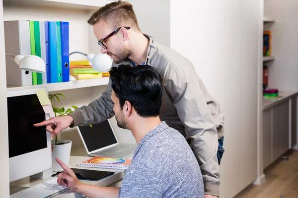 Serious gay couple using laptop — Stock Photo, Image