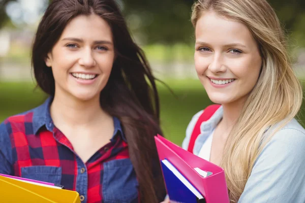 Smiling students holding binder Royalty Free Stock Photos