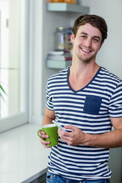 Handsome man holding mug — Stock Photo, Image