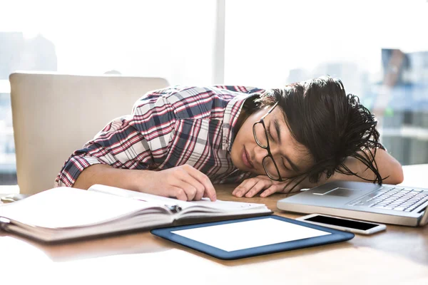 Hipster businessman falling asleep on desk — Stock Photo, Image