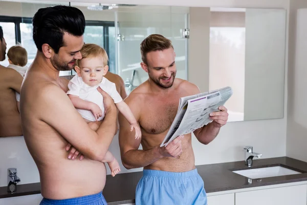 Sonriente pareja gay con niño — Foto de Stock