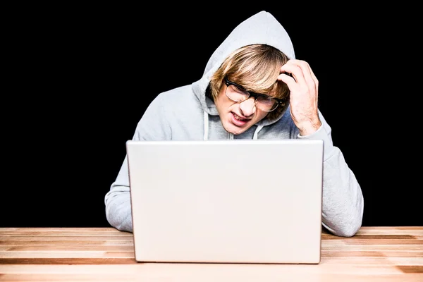 Man in hood jacket hacking laptop — Stock Photo, Image