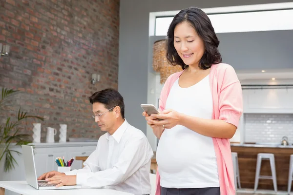 Zwangere vrouw met behulp van smartphone — Stockfoto