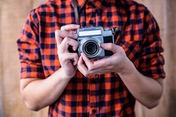 Hipster holding an old camera — Stock Photo, Image