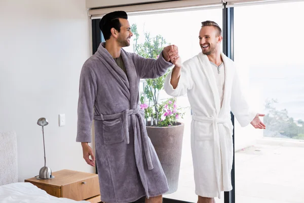 Gay couple dancing in bathrobe — Stock Photo, Image