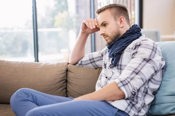 Worried man thinking on couch — Stock Photo, Image