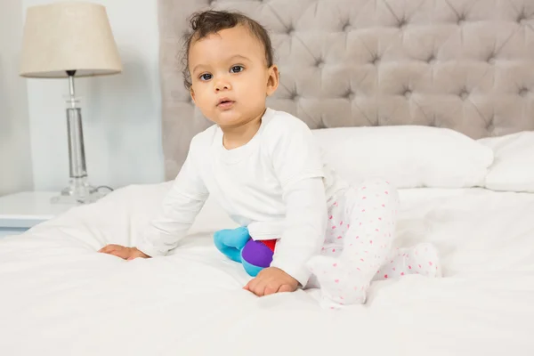 Cute baby sitting on bed — Stock Photo, Image