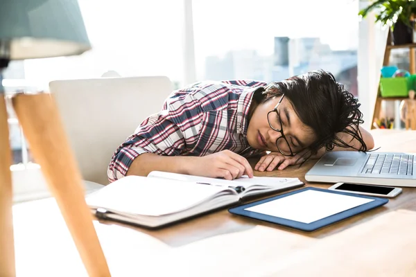 Hipster businessman falling asleep on desk — Stock Photo, Image