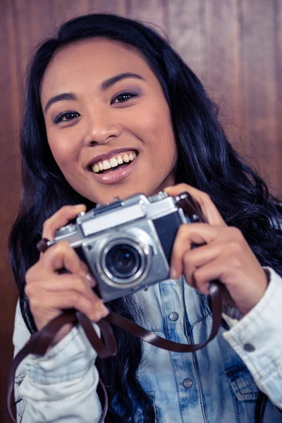 Asian woman holding digital camera — Stock Photo, Image