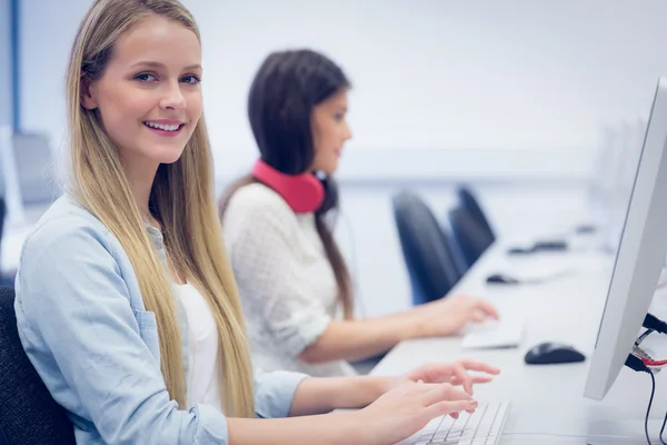 Smiling students using computer Stock Photo
