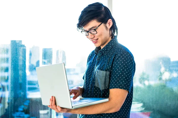Hipster businessman using laptop — Stock Photo, Image