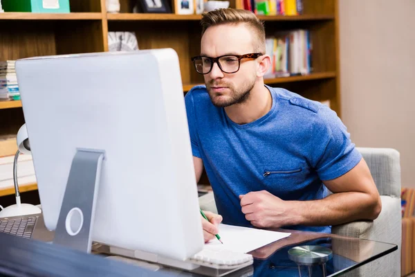 Serious designer drawing at desk — Stock Photo, Image