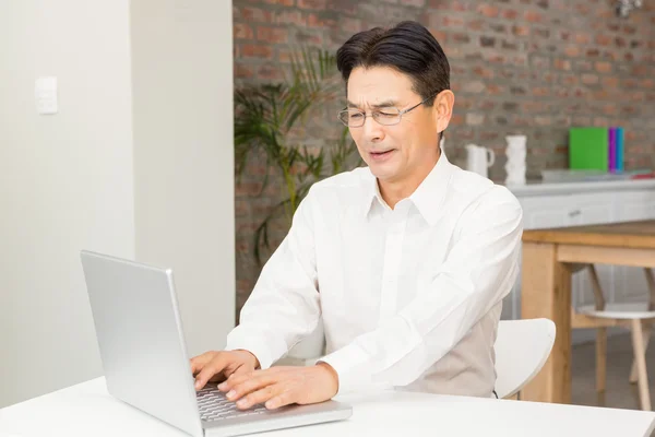 Smiling man using laptop — Stock Photo, Image