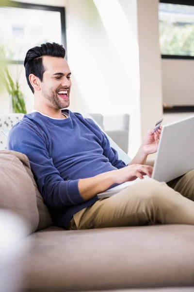 Handsome man doing shopping online — Stock Photo, Image