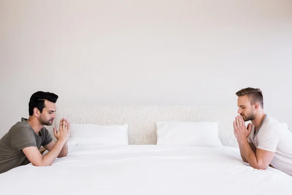 Handsome men praying in bedroom — Stock Photo, Image