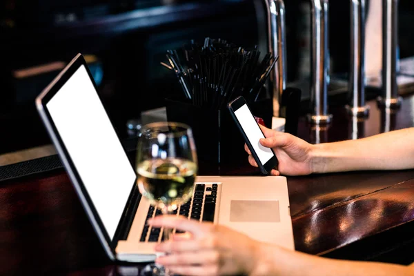 Mujer mensajes de texto y el uso de ordenador portátil con vino — Foto de Stock