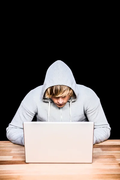 Man in hood jacket hacking laptop — Stock Photo, Image