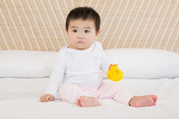 Cute baby holding plastic duck — Stockfoto