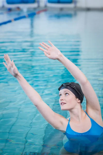 Vältränad kvinna stretching i vattnet — Stockfoto