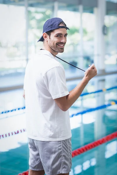 Serious trainer looking at stopwatch — Stock Photo, Image