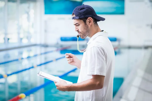 Serious trainer holding clipboard — Stock Photo, Image