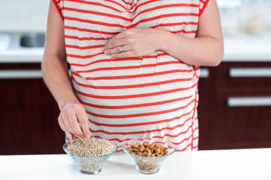 Pregnant woman eating cereals clipart