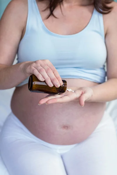 Mulher grávida tomando uma pílula — Fotografia de Stock