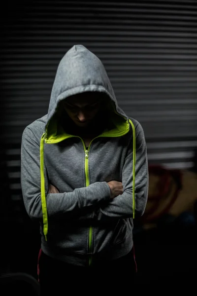 Athlete wearing hood with head down — Stock Photo, Image