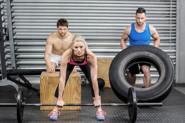 Fit people doing exercises — Stock Photo, Image