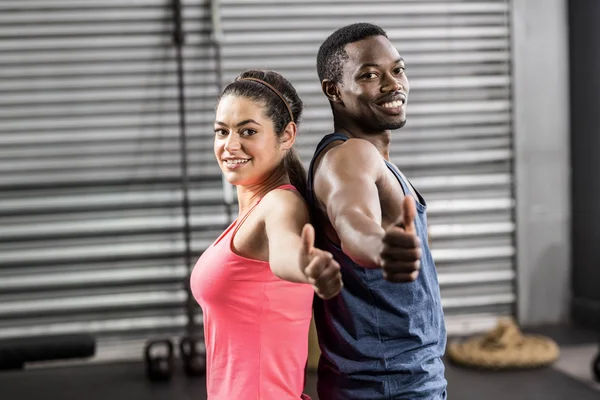 Fit couple back to back — Stock Photo, Image