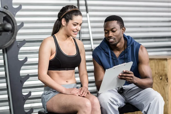 Athletic woman and trainer smiling to camera — Stock Photo, Image