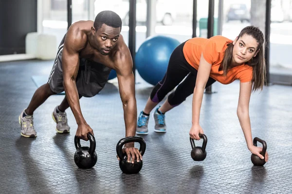 Athletic man and woman working out — Stock Photo, Image