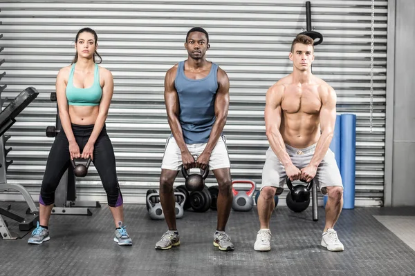 Fit people lifting dumbbells — Stock Photo, Image