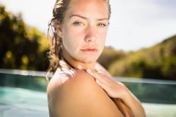 Unsmiling blonde in the pool — Stock Photo, Image