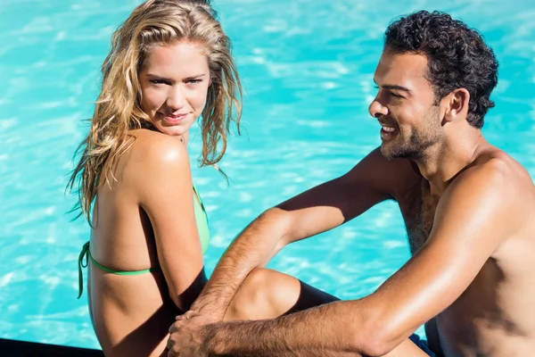 Cute couple sitting at the edge — Stock Photo, Image