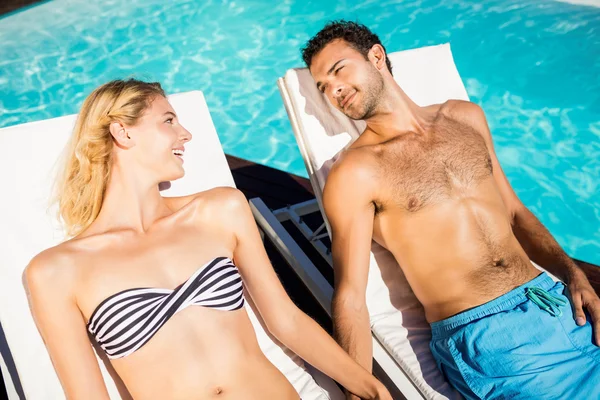 Cute couple relaxing on deckchairs — Stock Photo, Image