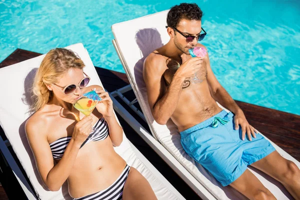 Couple relaxing on deckchairs — Stock Photo, Image