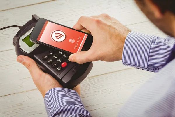 Man using smartphone to express pay — Stock Photo, Image