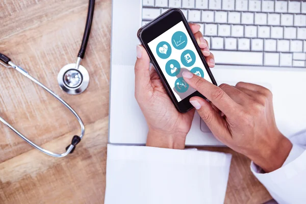 Doctor using smartphone on desk — Stock Photo, Image