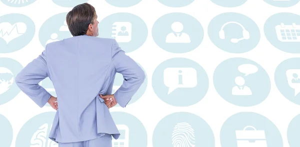 Serious businessman with hands on hips — Stock Photo, Image
