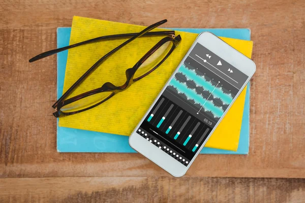 Smartphone and glasses on table — Stock Photo, Image