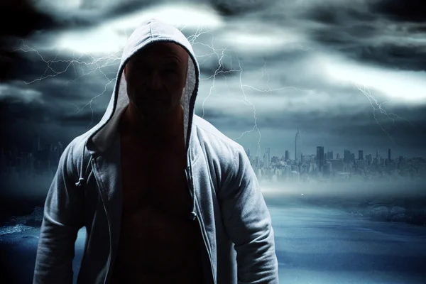 Man in hood against stormy sky — Stock Photo, Image